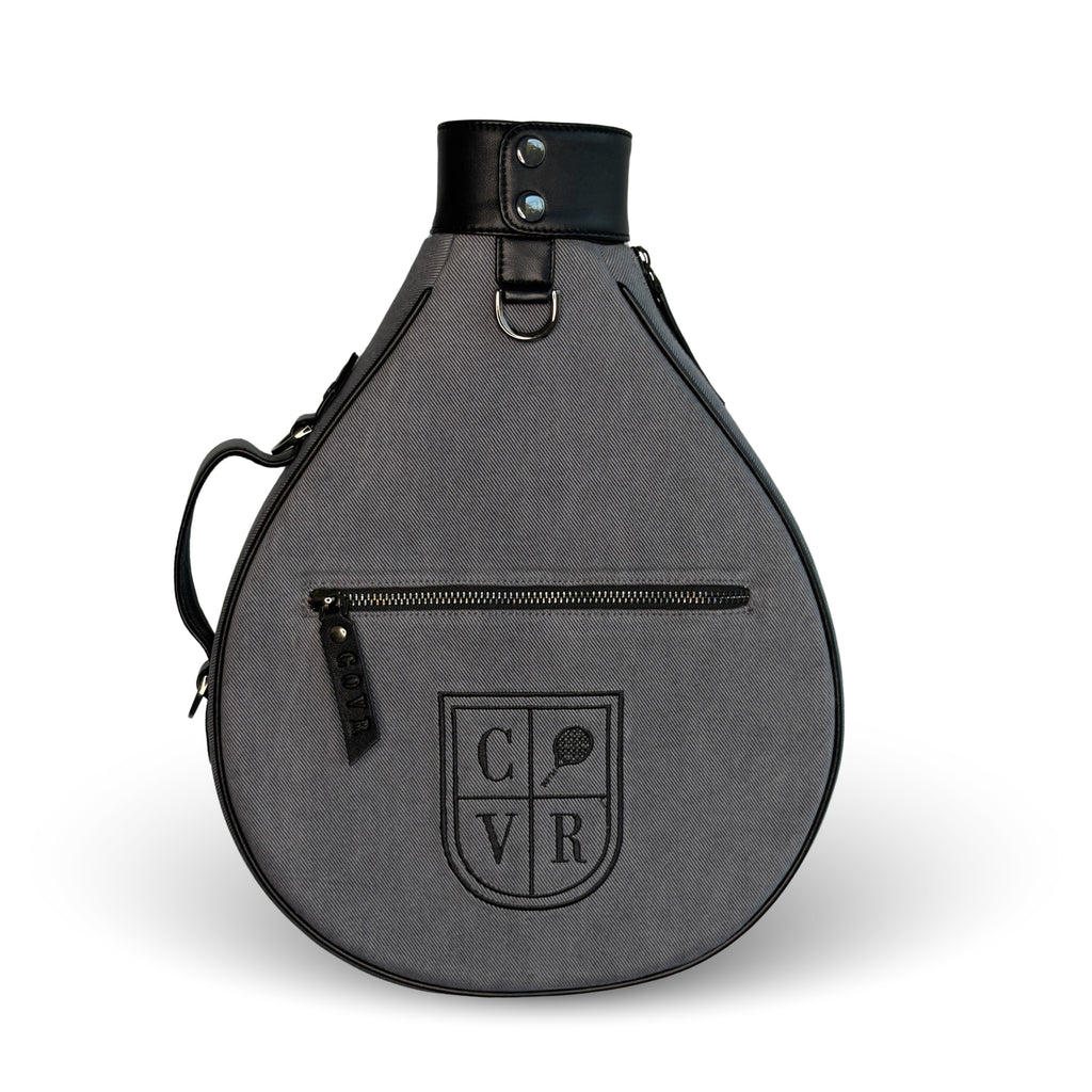Ash COVR padel racket cover in grey denim with black leather trim, front view
