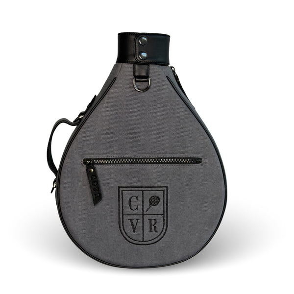 Ash COVR padel racket cover in grey denim with black leather trim, front view