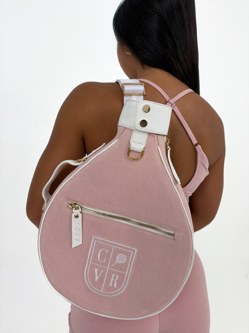 Player wearing a Baby Pink COVR padel racket cover on her back