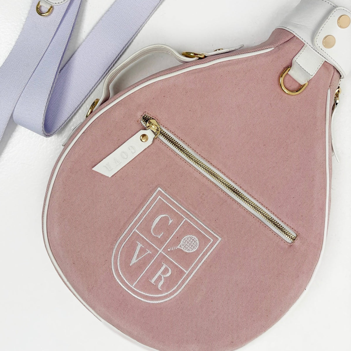 Baby Pink COVR padel racket cover with its shoulder strap