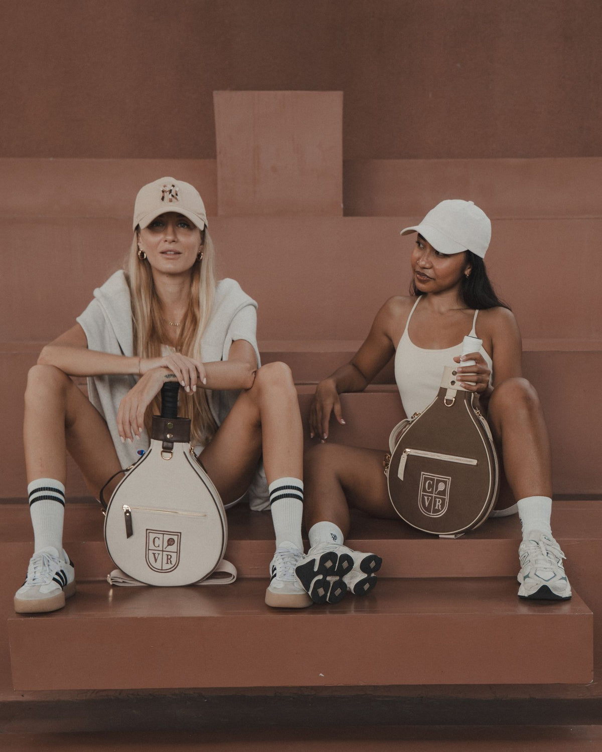 Two players with Latte and Mocha COVR covers on court steps
