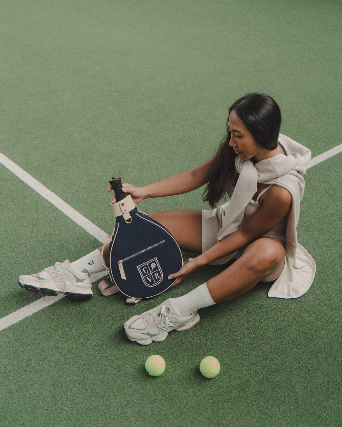 Navy COVR cover held on the padel court