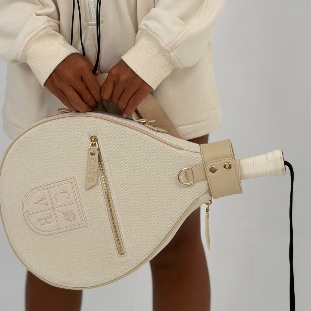 Vanilla Cream COVR padel racket cover with a racket inside