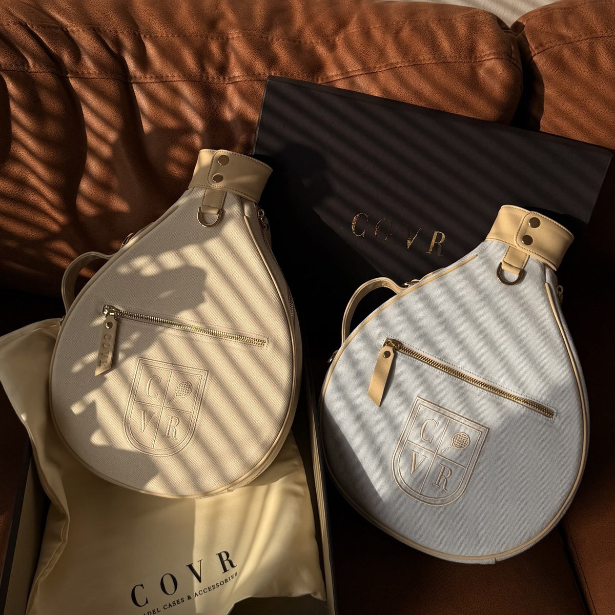 Vanilla Cream and Sky Denim COVR covers in their gift box on a sofa